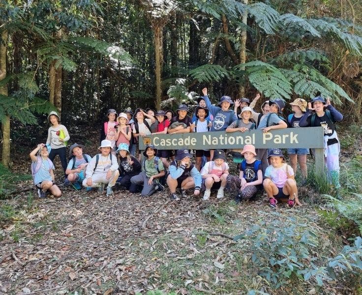 students gathered around Cascade National Park sign